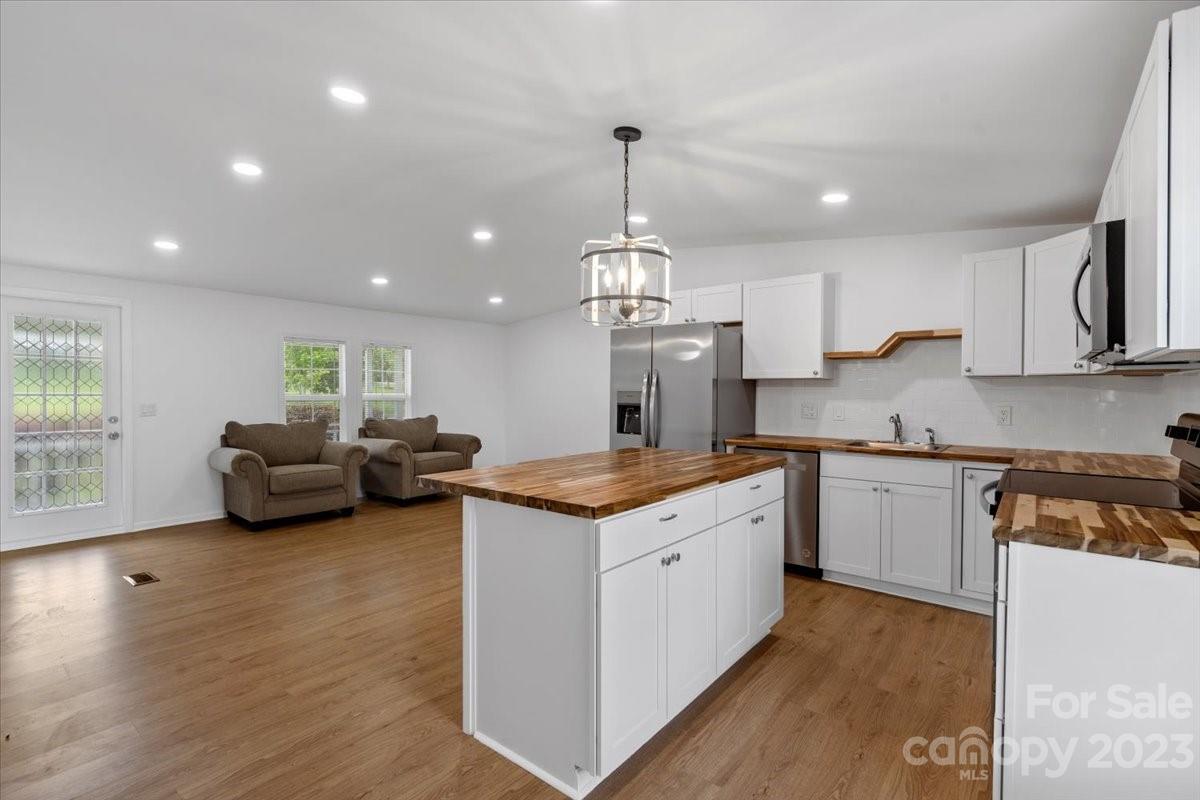 1724 Ruben Road Monroe, NC 28112 - Photo 11 of 28 a open kitchen with stainless steel appliances granite countertop a stove and a sink