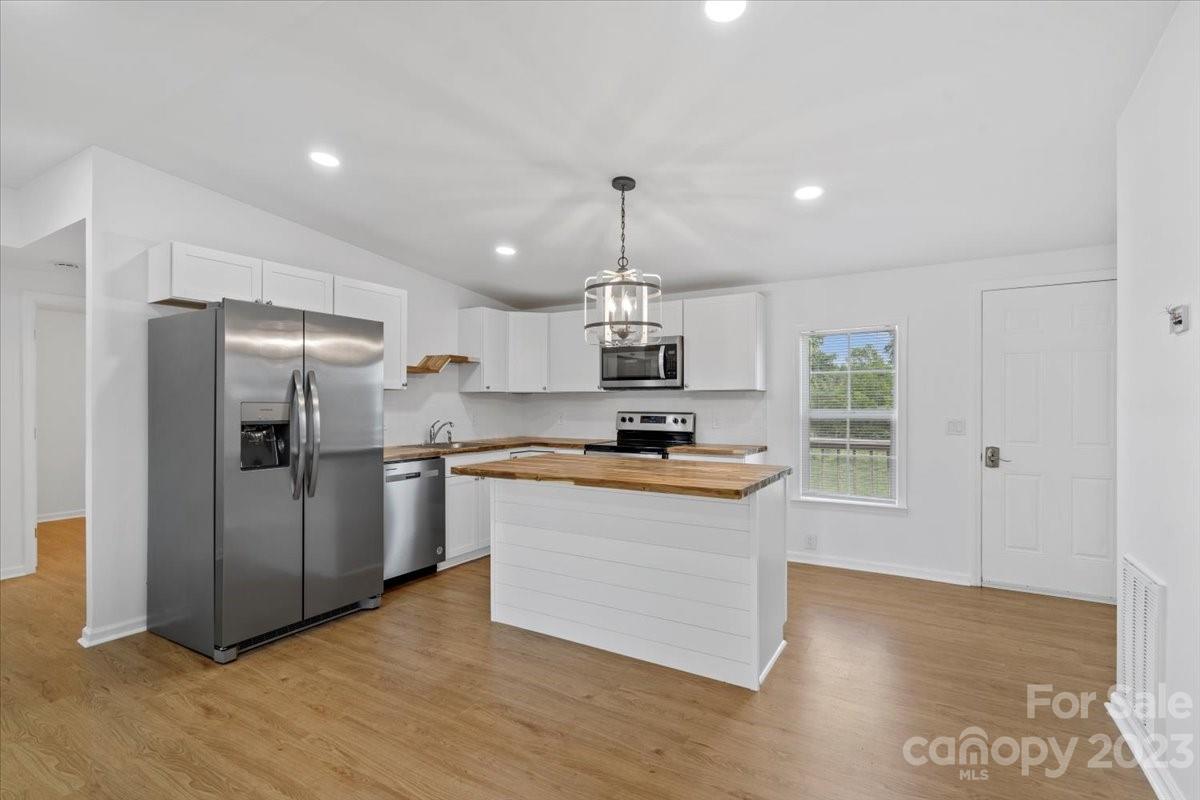 1724 Ruben Road Monroe, NC 28112 - Photo 13 of 28 a kitchen with stainless steel appliances granite countertop a refrigerator a stove a sink and a microwave