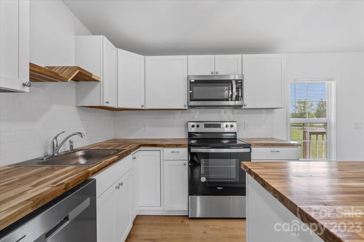 1724 Ruben Road Monroe, NC 28112 - Photo 15 of 28 a kitchen with cabinets stainless steel appliances and a sink