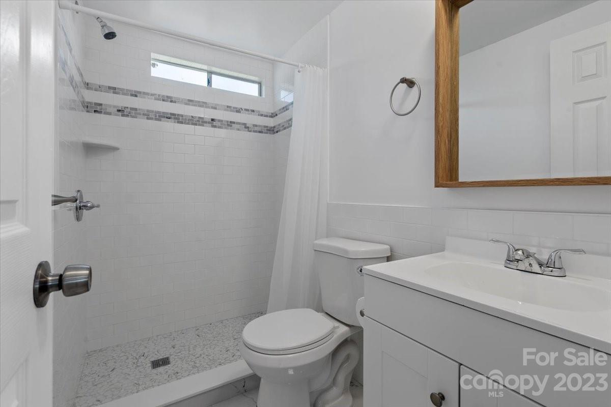 1724 Ruben Road Monroe, NC 28112 - Photo 19 of 28 a bathroom with a sink a toilet and shower