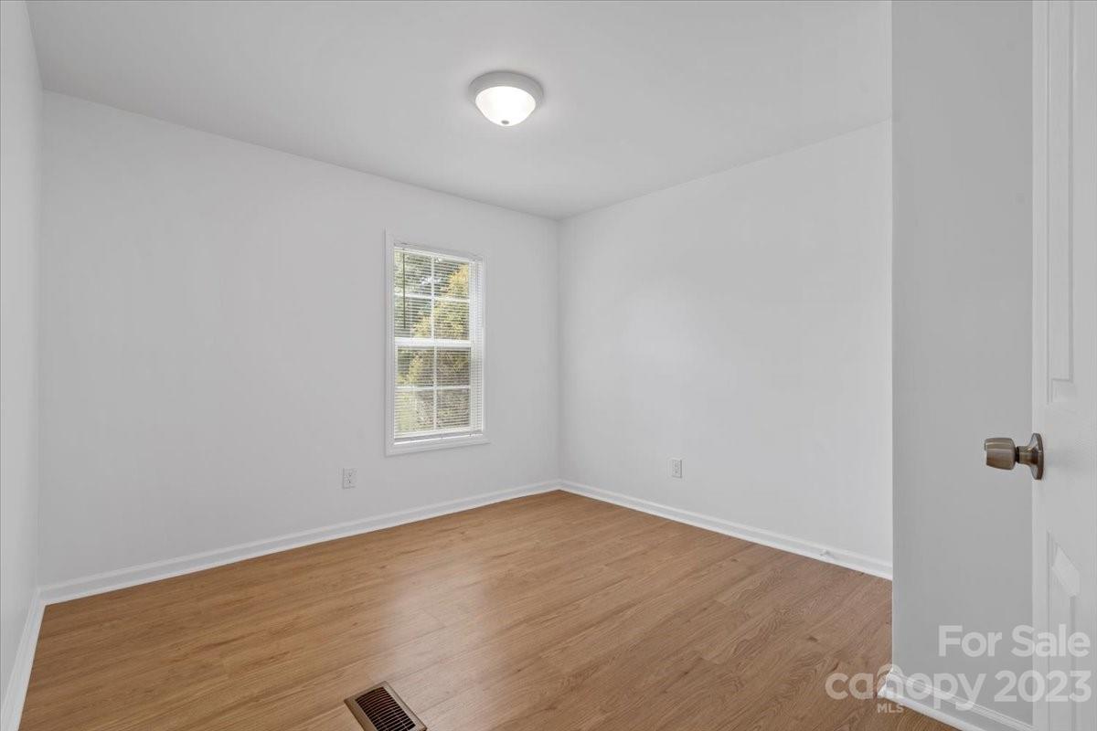 1724 Ruben Road Monroe, NC 28112 - Photo 21 of 28 an empty room with wooden floor and windows