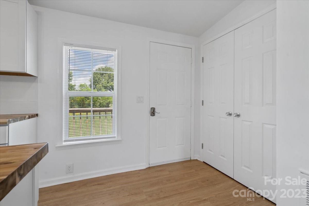 1724 Ruben Road Monroe, NC 28112 - Photo 8 of 28 a view of an empty room with wooden floor and a window
