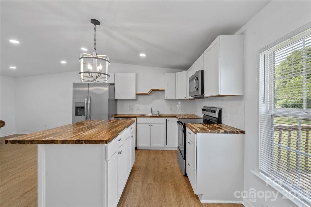 1724 Ruben Road Monroe, NC 28112 - Photo 10 of 28 a kitchen with stainless steel appliances granite countertop a sink stove and refrigerator