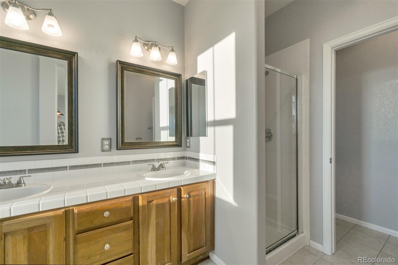 10533 Ashfield Street, Unit D Highlands Ranch, CO 80126 - Photo 13 of 25 a bathroom with a sink and a mirror