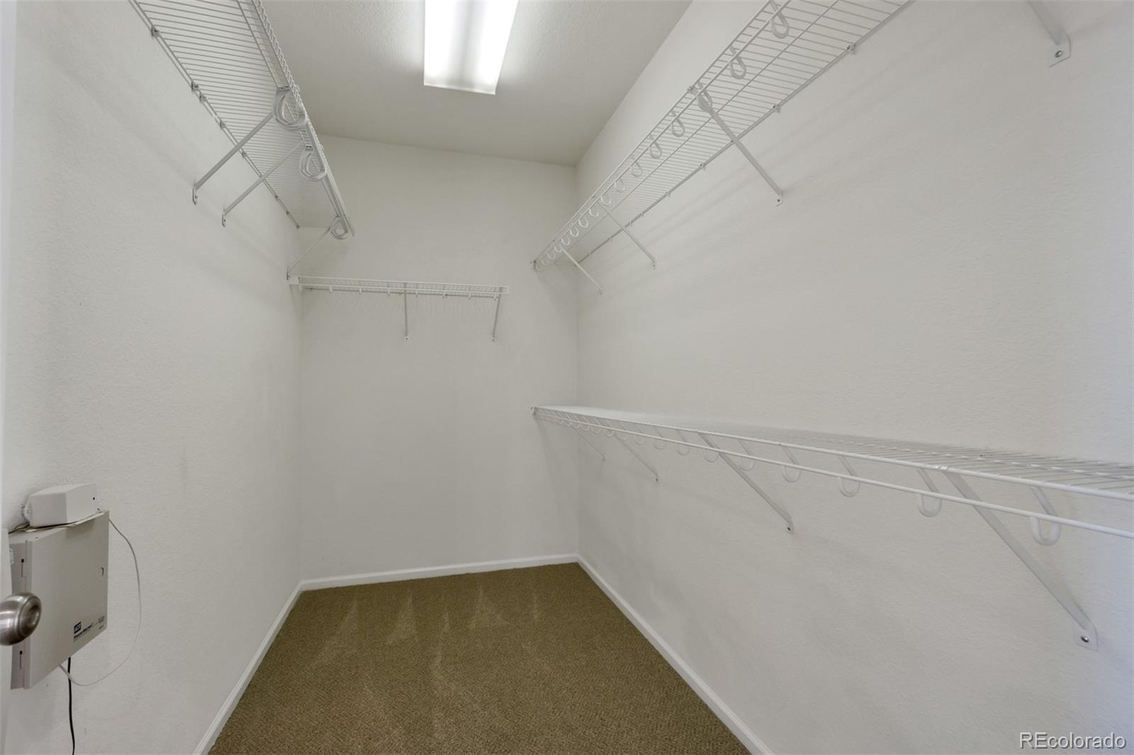 10533 Ashfield Street, Unit D Highlands Ranch, CO 80126 - Photo 14 of 25 a view of a room with racks on the wall