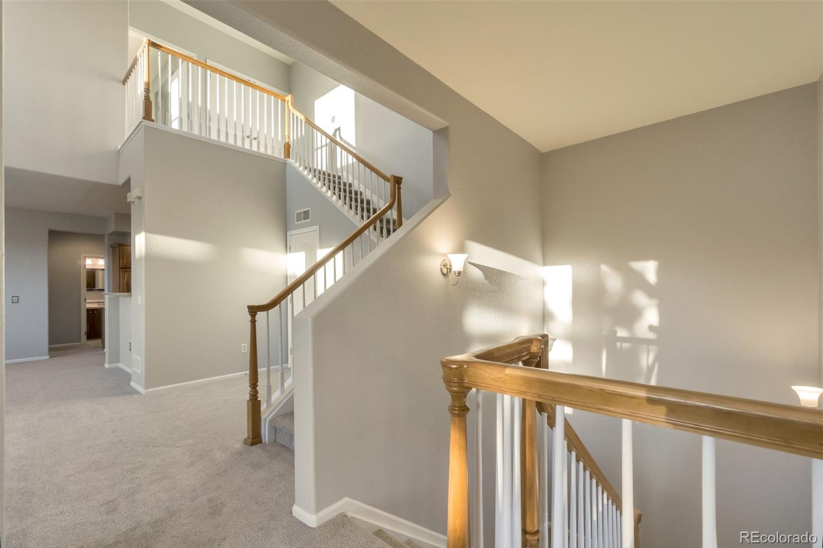 10533 Ashfield Street, Unit D Highlands Ranch, CO 80126 - Photo 18 of 25 a view of entryway and hall with wooden floor