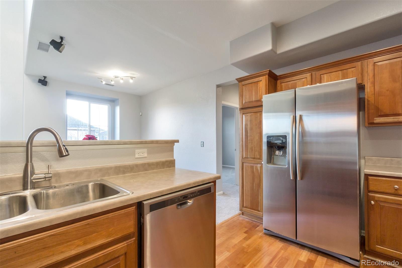 10533 Ashfield Street, Unit D Highlands Ranch, CO 80126 - Photo 20 of 25 a view of a refrigerator a sink and cabinets