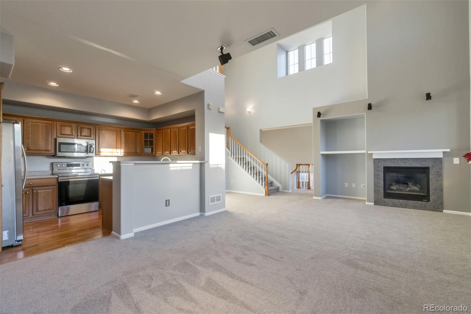 10533 Ashfield Street, Unit D Highlands Ranch, CO 80126 - Photo 3 of 25 a view of a kitchen with a sink and a fireplace