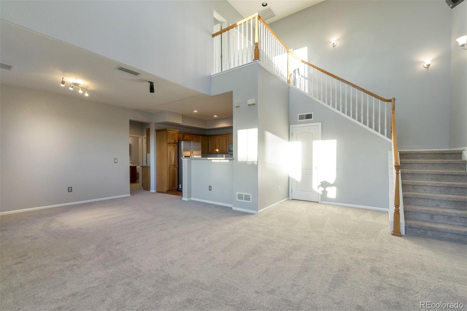10533 Ashfield Street, Unit D Highlands Ranch, CO 80126 - Photo 5 of 25 a view of an empty room and windows
