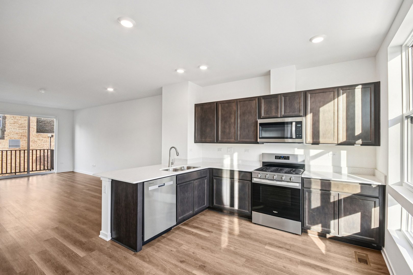 373 Summit Circle Lombard, IL 60148 - Photo 6 of 45 a kitchen with stainless steel appliances granite countertop a stove top oven a sink dishwasher and a refrigerator with wooden floor