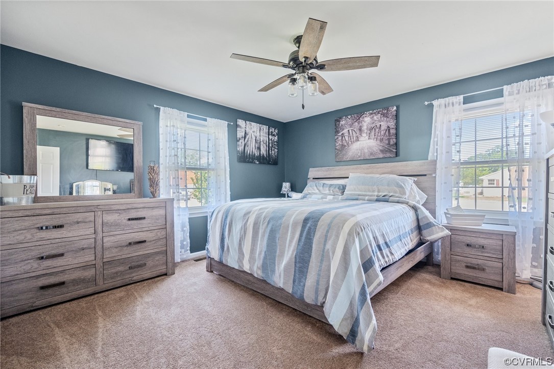 366 Brout Drive Hampton, VA 23666 - Photo 24 of 32 a bedroom with a bed a chandelier and a mirror on dresser