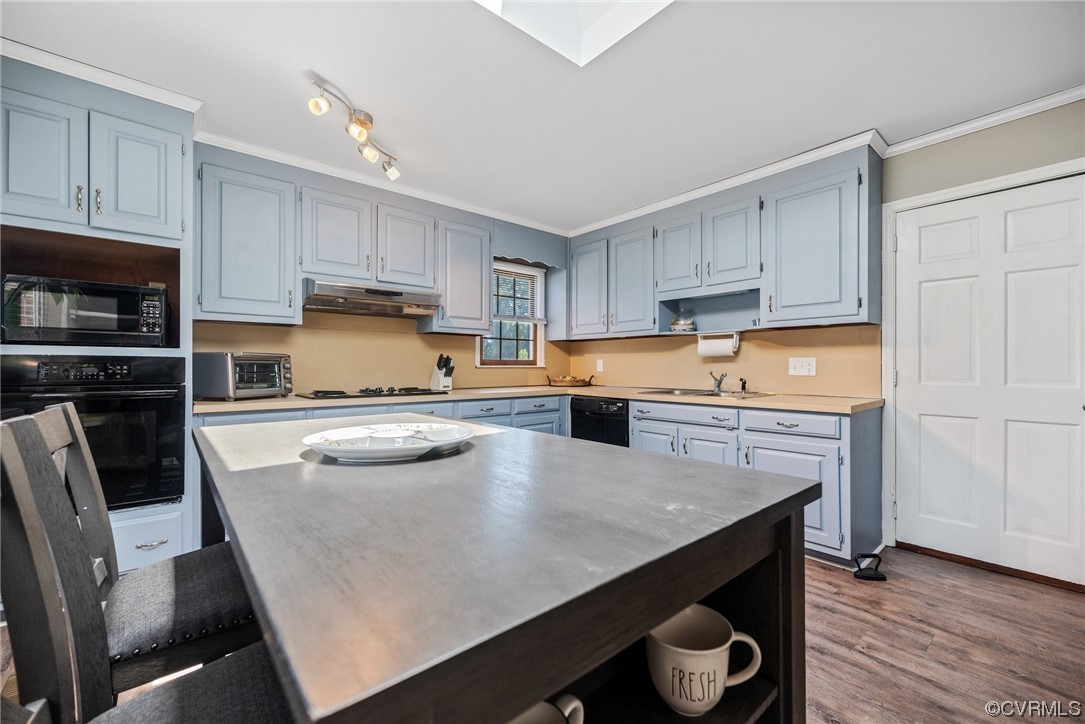 366 Brout Drive Hampton, VA 23666 - Photo 7 of 32 a kitchen with kitchen island a stove a sink a microwave and wooden cabinets