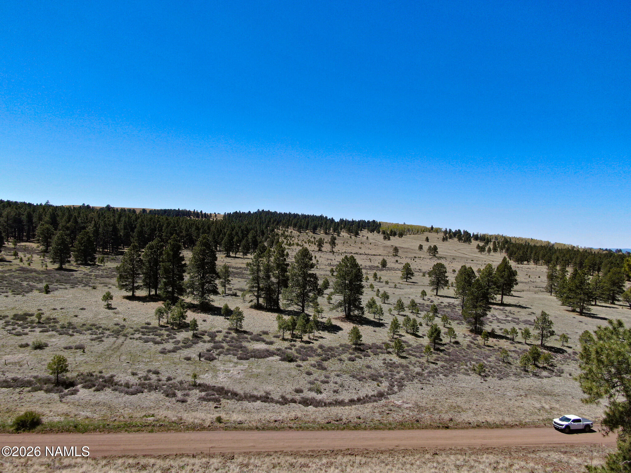1 Hart Prairie Road Flagstaff, AZ 86001 - Photo 8 of 25 a view of a dry yard with wooden fence