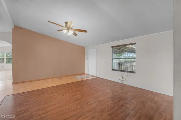 wooden floor in an empty room with a window