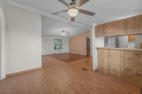 a view of a kitchen with a sink cabinets and wooden floor