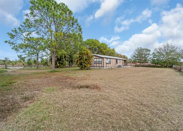 a view of a house with yard and sitting area