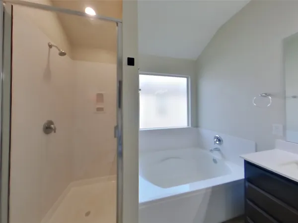 a bathroom with a bathtub and a shower