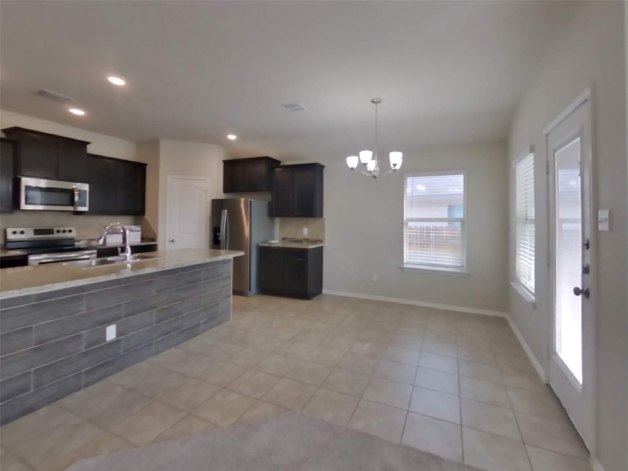 1152 Ibis Falls Loop Jarrell, TX 76537 - Photo 5 of 19 a large kitchen with a large counter top stainless steel appliances and cabinets