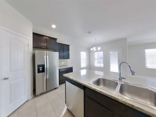 a kitchen with refrigerator and sink