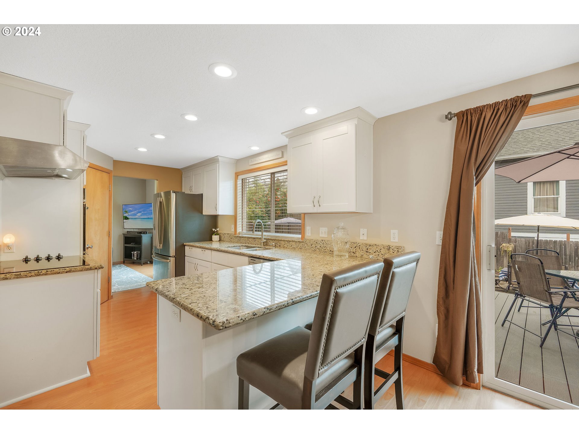 103 Park Street Gaston, OR 97119 - Photo 15 of 47 a kitchen with stainless steel appliances granite countertop sink refrigerator dining table and chairs