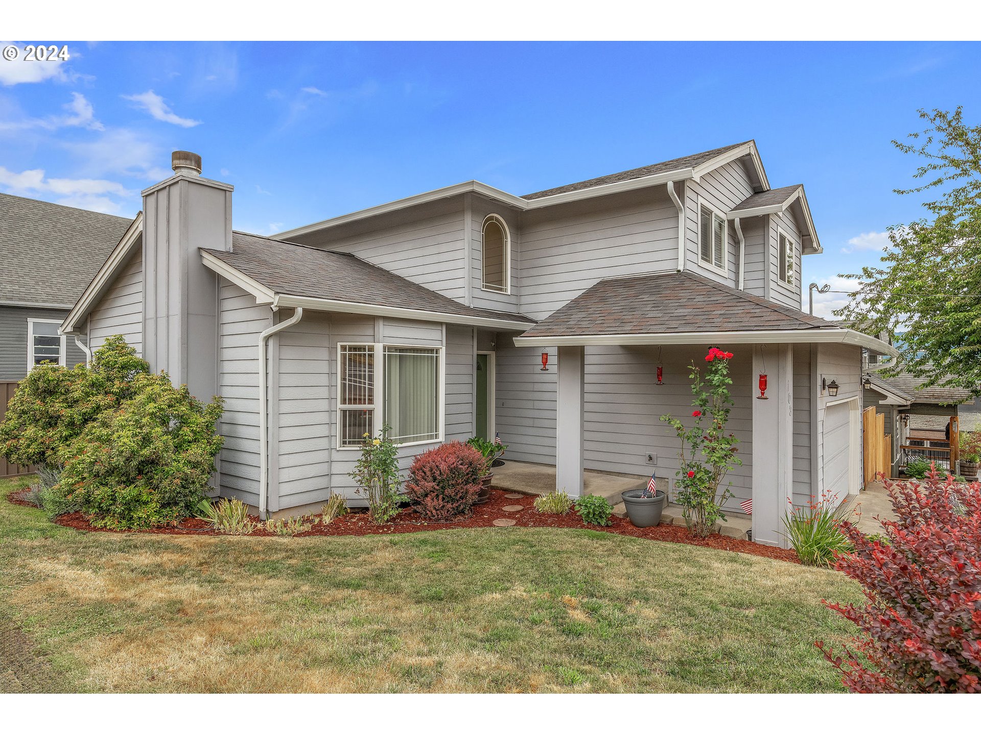103 Park Street Gaston, OR 97119 - Photo 2 of 47 a front view of a house with garden