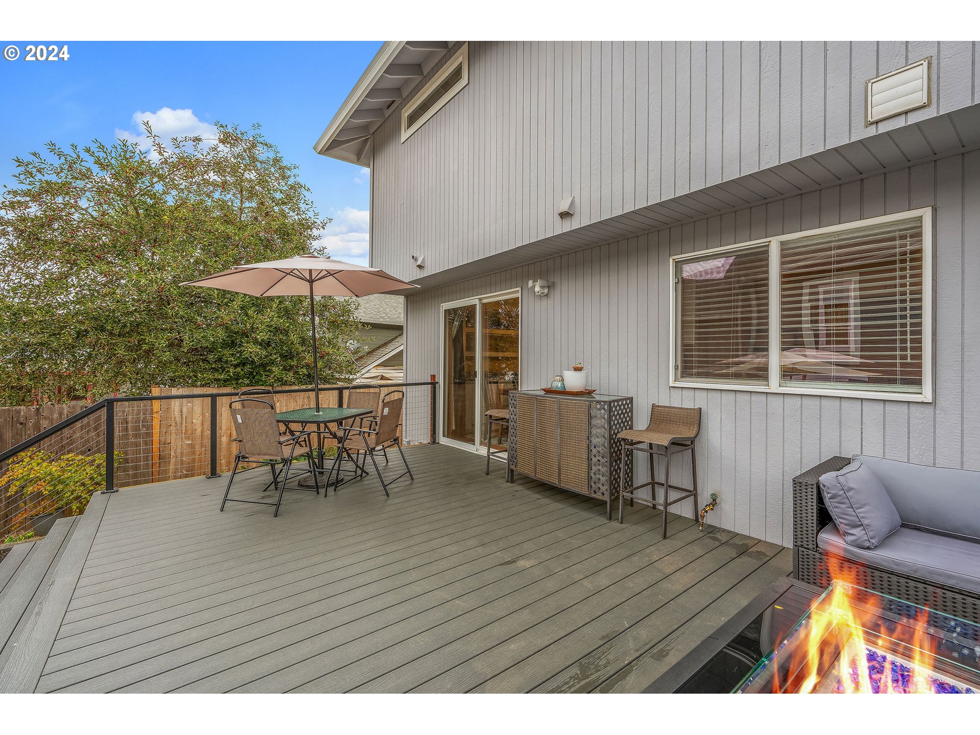 103 Park Street Gaston, OR 97119 - Photo 34 of 47 a view of a deck with table and chairs with wooden floor and fence