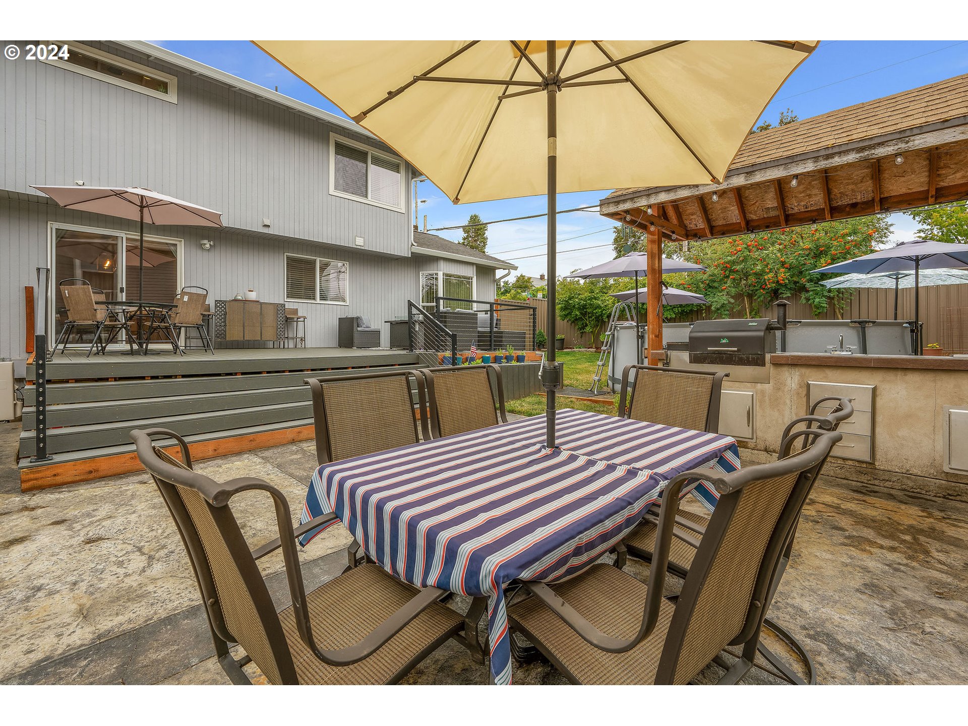 103 Park Street Gaston, OR 97119 - Photo 36 of 47 a view of a patio with table and chairs under an umbrella
