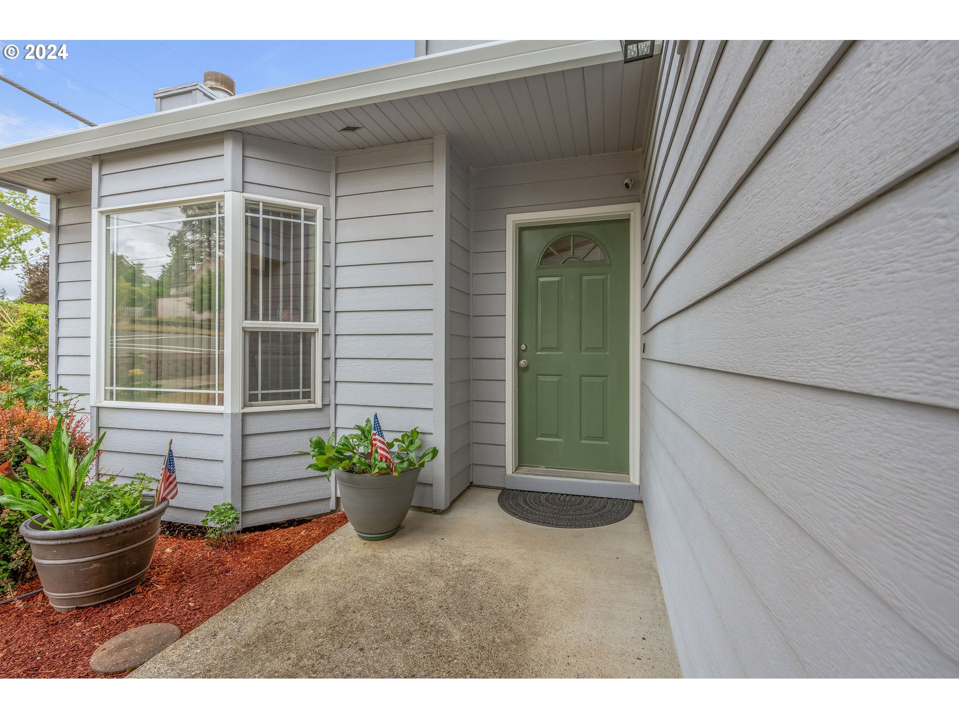 103 Park Street Gaston, OR 97119 - Photo 5 of 47 a view of a backyard door with potted plants