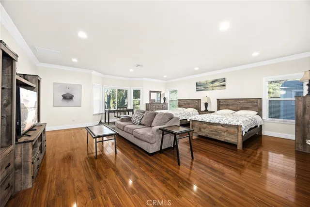 a bedroom with furniture and a wooden floor