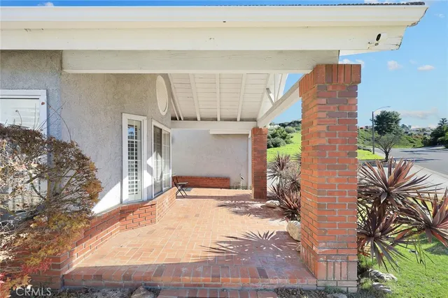 a view of a dining room and livingroom with furniture wooden floor a chandelier