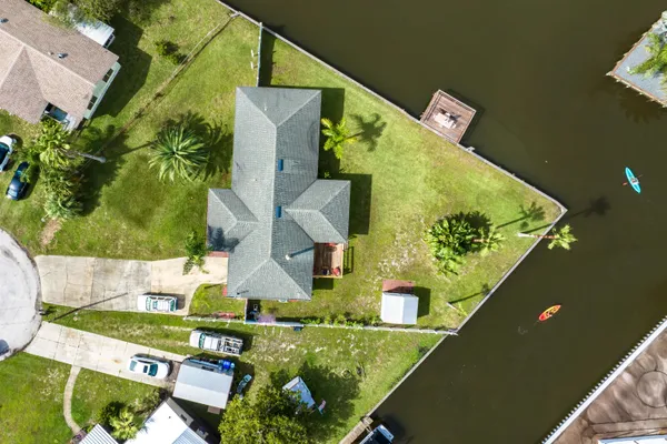 an aerial view of a house with a yard