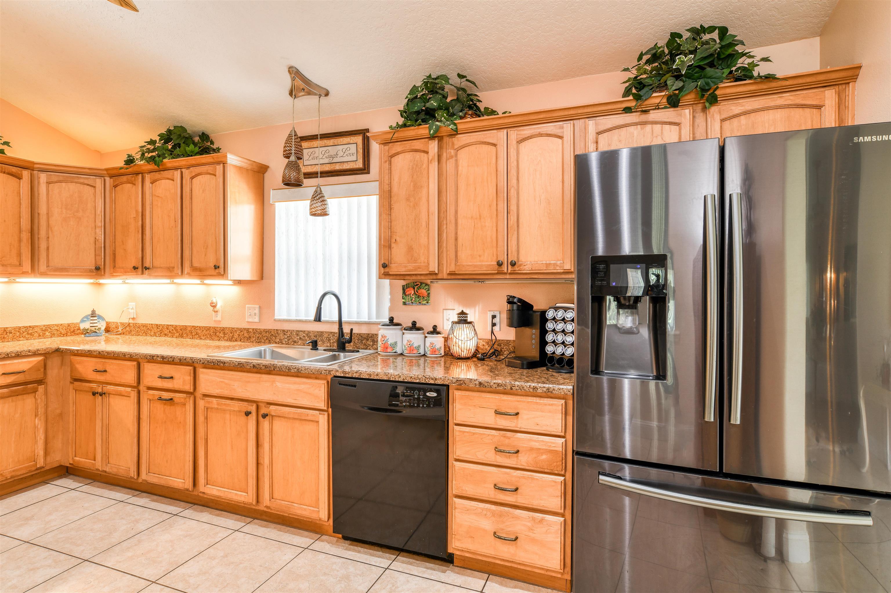 298 Ventura Road St. Augustine, FL 32080 - Photo 13 of 55 a kitchen with stainless steel appliances a refrigerator sink and cabinets