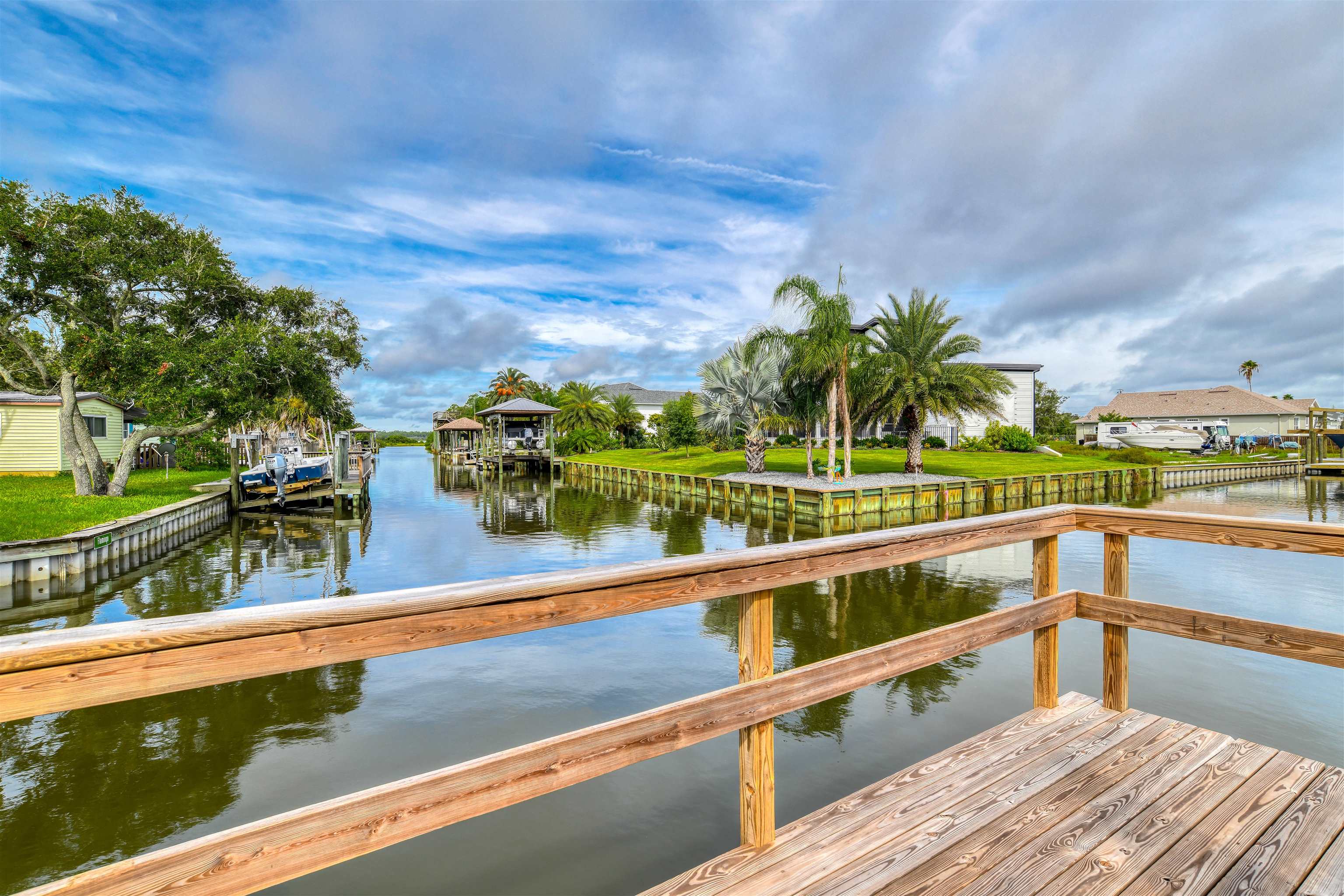 298 Ventura Road St. Augustine, FL 32080 - Photo 24 of 55 a view of a swimming pool with a lawn chairs and plants