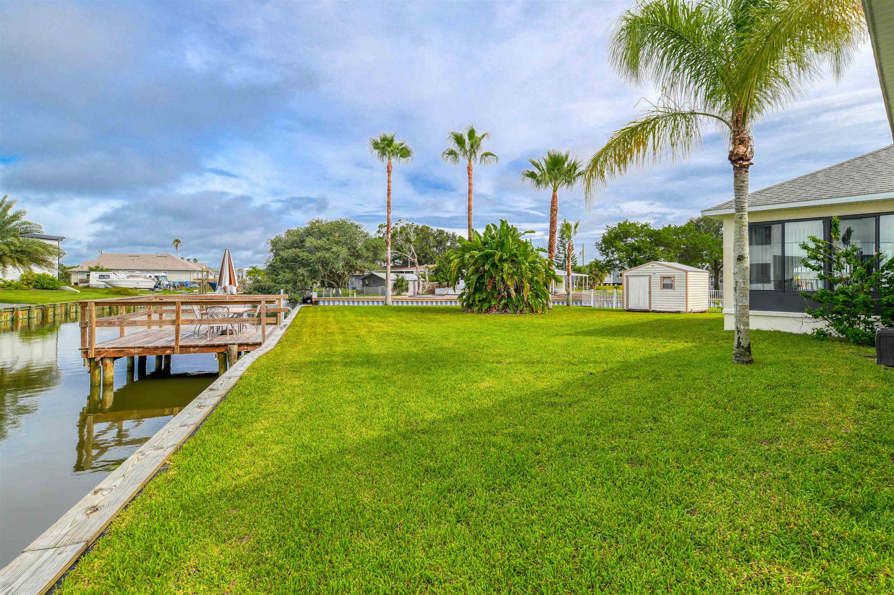 298 Ventura Road St. Augustine, FL 32080 - Photo 25 of 55 a view of a swimming pool with a garden and plants