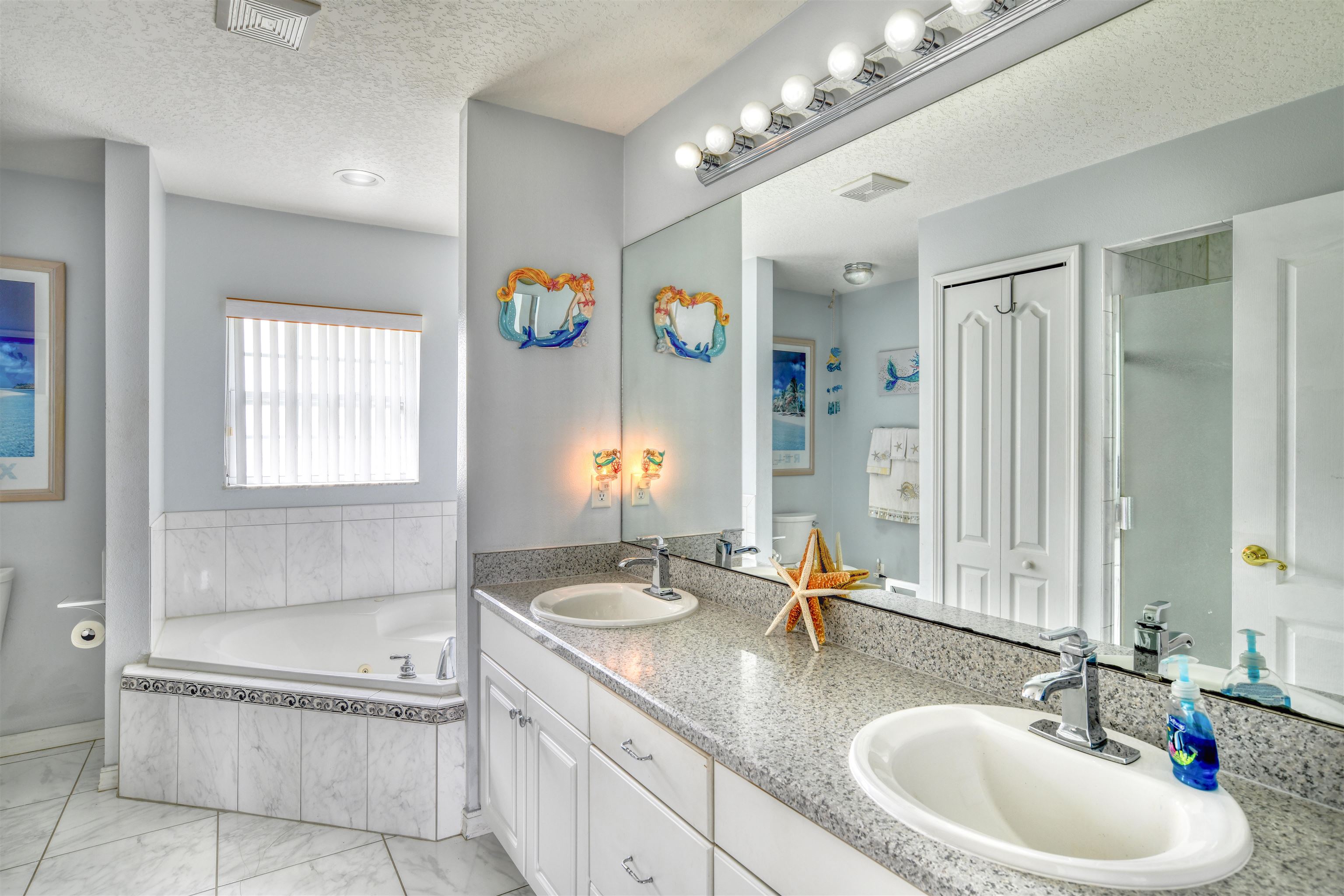 298 Ventura Road St. Augustine, FL 32080 - Photo 30 of 55 a bathroom with a granite countertop double vanity sink a mirror and a bathtub
