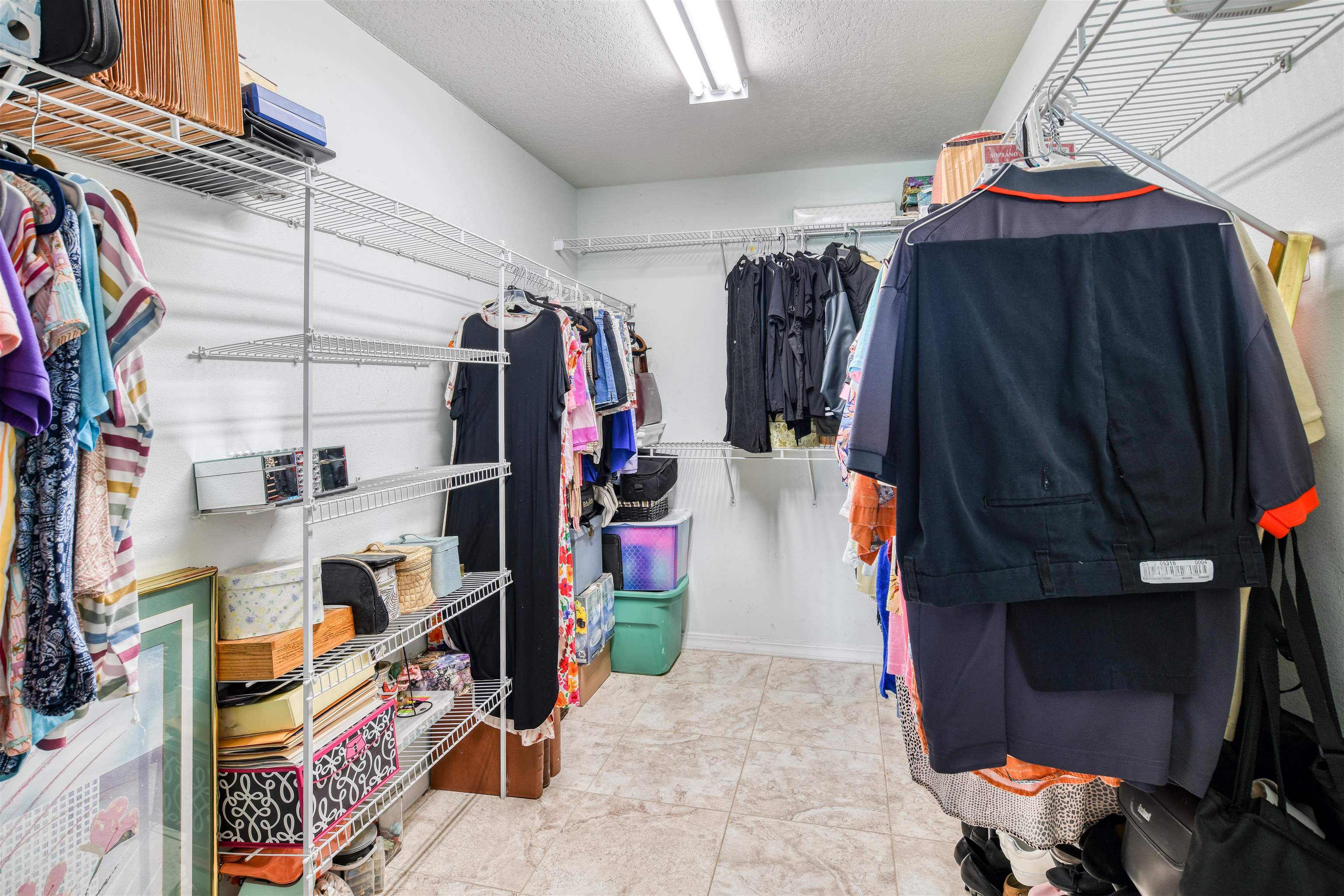 298 Ventura Road St. Augustine, FL 32080 - Photo 32 of 55 a view of walk in closet with clothes and shoes