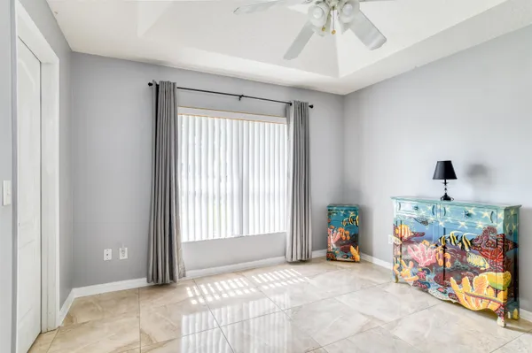 a living room with furniture tv and large windows