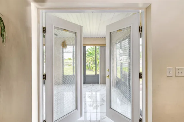 a spacious bedroom with a bed and a flat screen tv