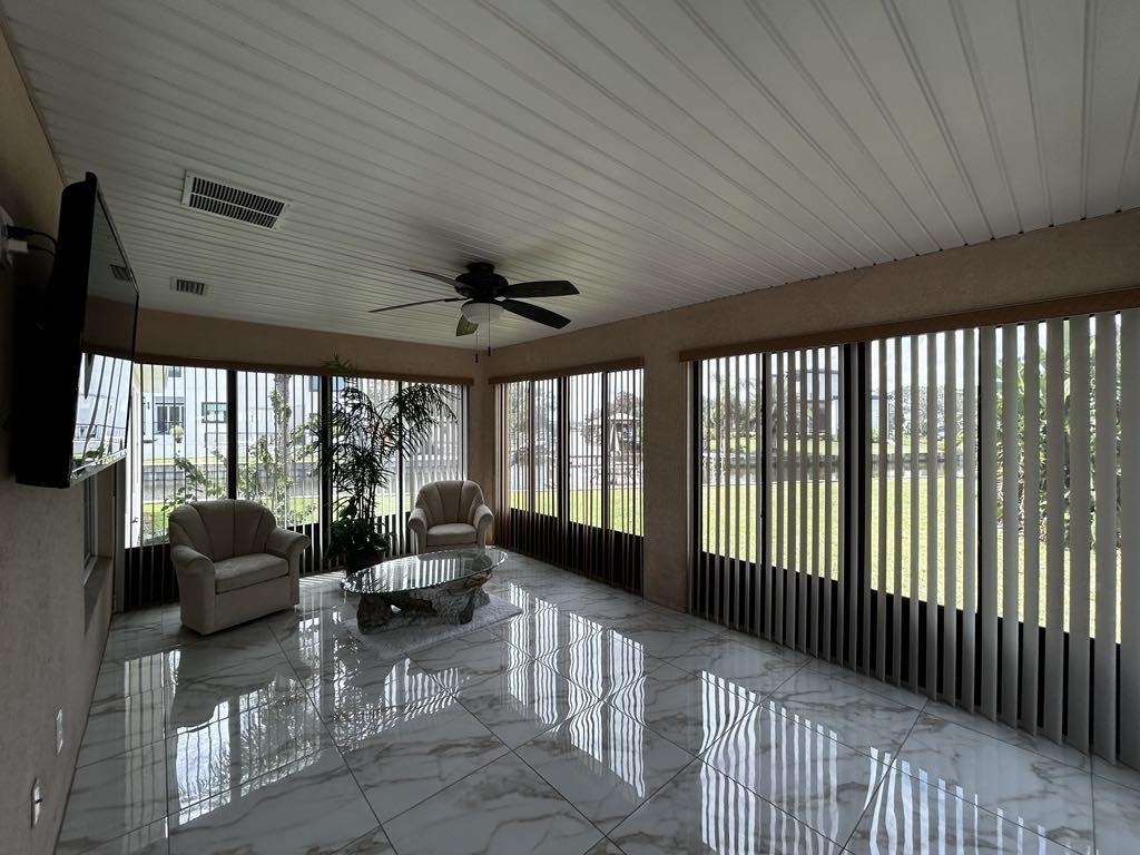 298 Ventura Road St. Augustine, FL 32080 - Photo 40 of 55 a living room with furniture tv and large windows