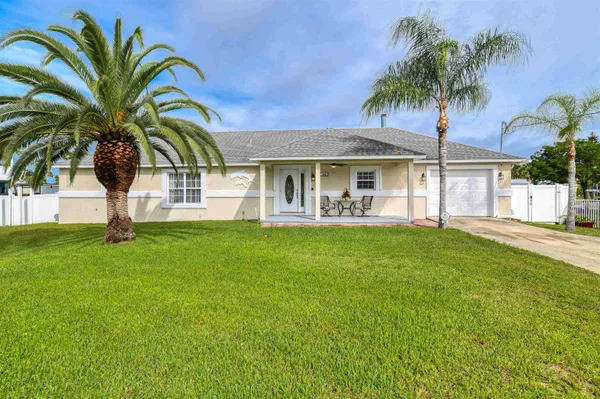 a view of a house with backyard porch and wooden fence