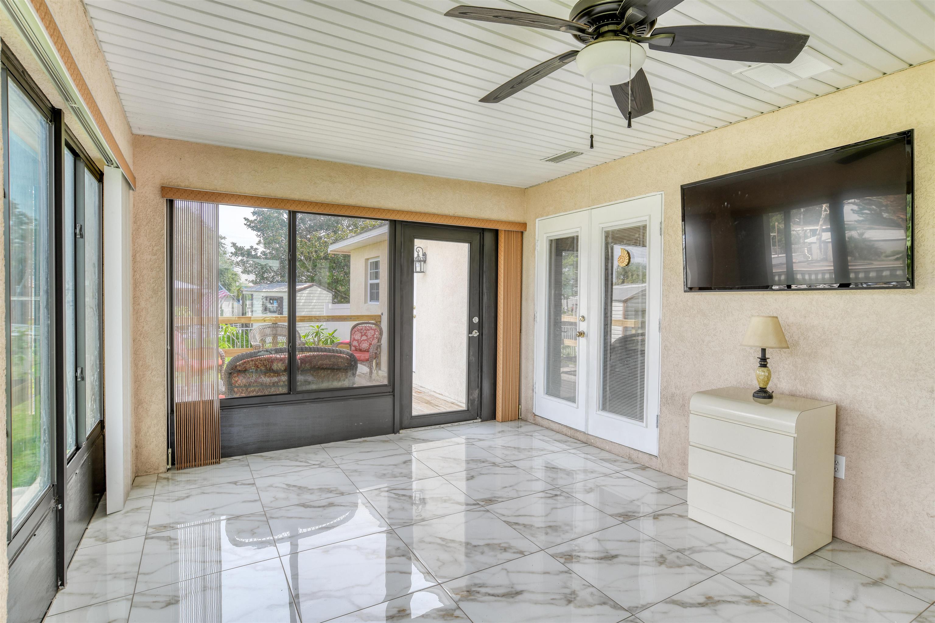 298 Ventura Road St. Augustine, FL 32080 - Photo 42 of 55 a spacious bedroom with a bed and a flat screen tv