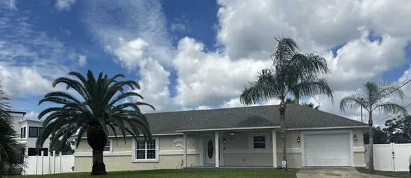 a view of a house with pool and sitting area