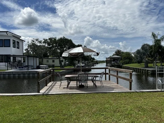 a view of a hallway with entryway and front door