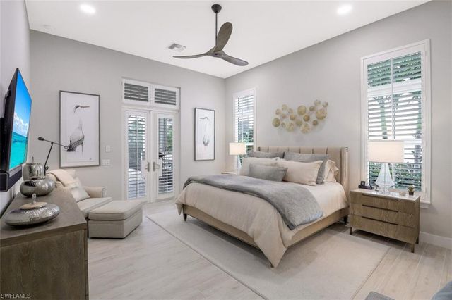 a bedroom with bed and a flat screen tv