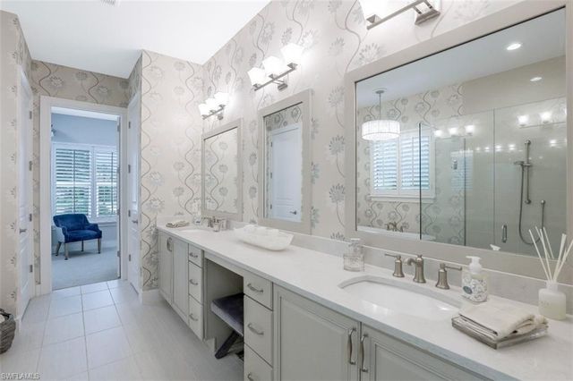 a bathroom with a granite countertop sink a toilet and shower