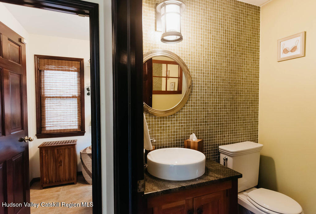 1 Rapp Hill Road New Paltz, NY 12561 - Photo 27 of 45 a bathroom with a toilet a sink and mirror