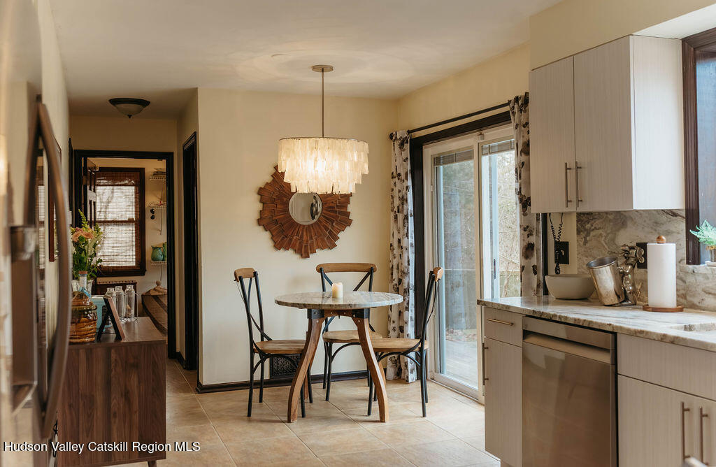 1 Rapp Hill Road New Paltz, NY 12561 - Photo 10 of 45 a kitchen with stainless steel appliances kitchen island granite countertop dining table chairs and granite counter top