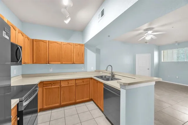 a kitchen with a sink cabinets and a large window
