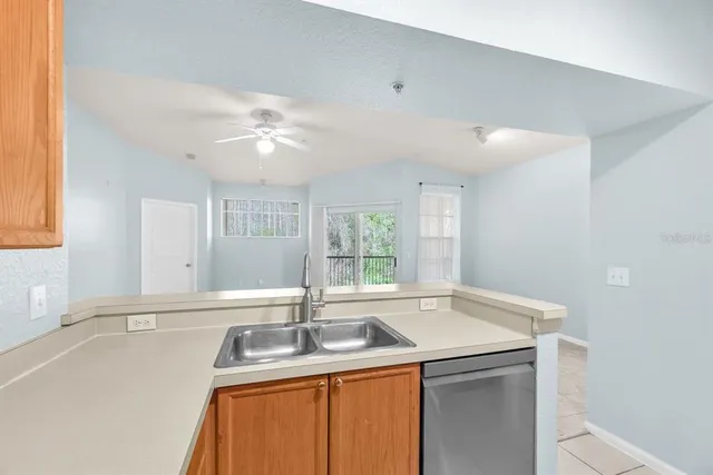 a kitchen with a refrigerator and a stove top oven