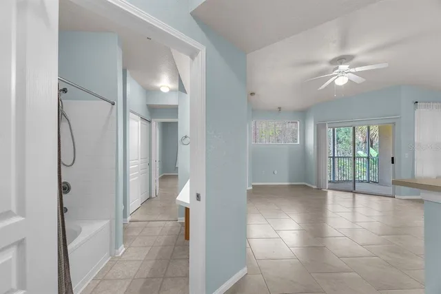 a bathroom with a tub sink mirror and shower